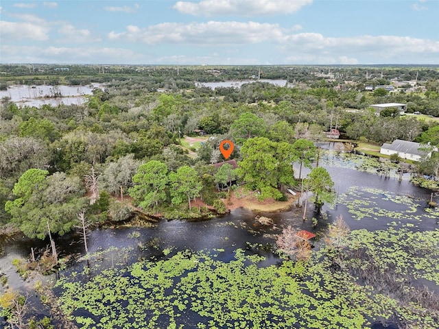 aerial view with a water view and a forest view