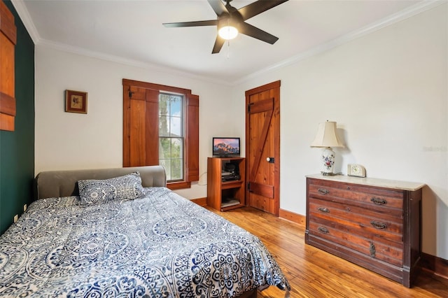 bedroom with a ceiling fan, light wood-type flooring, baseboards, and ornamental molding