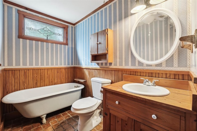 full bathroom featuring a wainscoted wall, a freestanding bath, and wallpapered walls