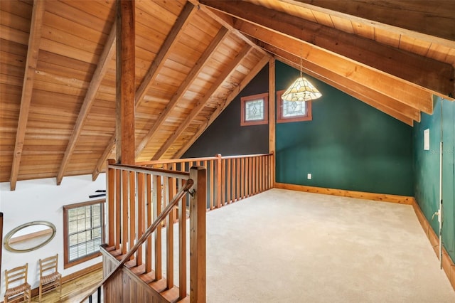 additional living space with baseboards, carpet, lofted ceiling with beams, and wood ceiling