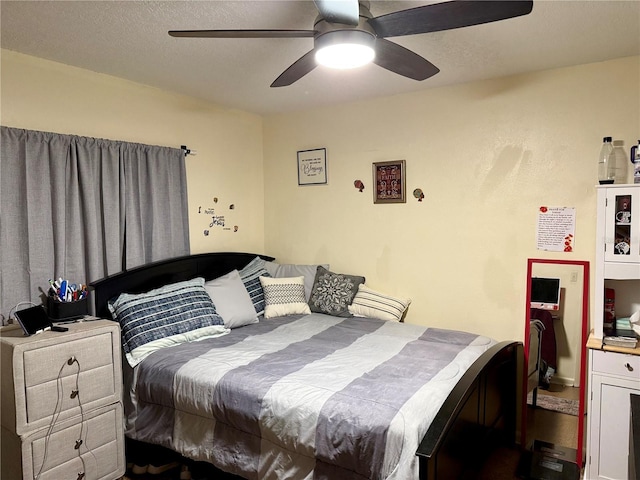 bedroom featuring a textured ceiling and ceiling fan