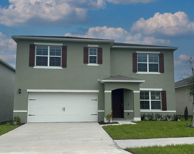 view of front of home with a garage and a front yard