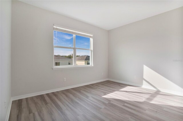 unfurnished room with light hardwood / wood-style flooring