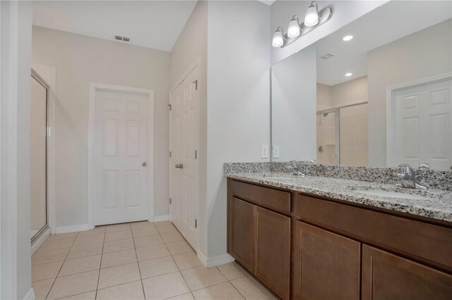 bathroom featuring vanity, tile patterned flooring, and an enclosed shower