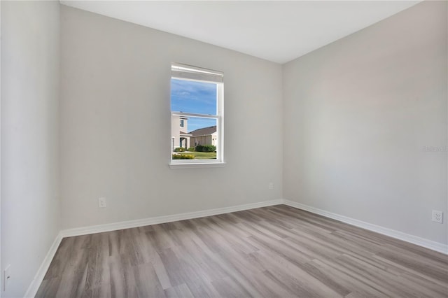 spare room with light hardwood / wood-style flooring