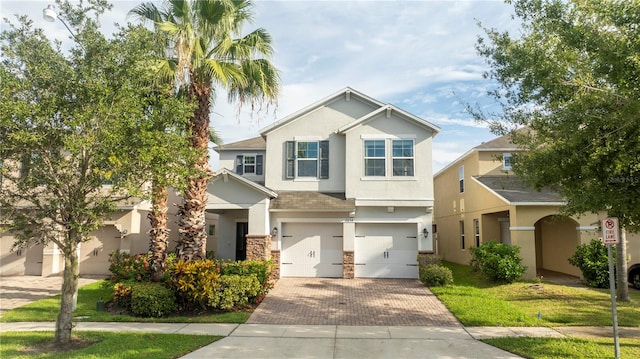 view of front of property with a front yard and a garage