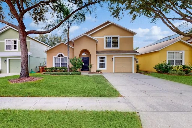 view of property featuring a front yard and a garage