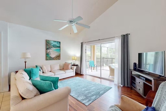 living room featuring ceiling fan, wood-type flooring, and lofted ceiling