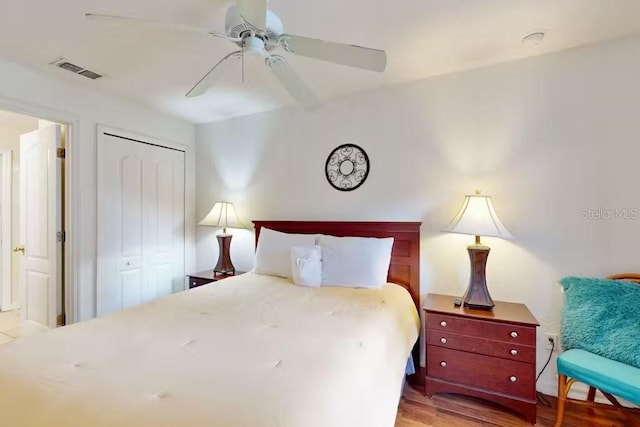 bedroom with a closet, ceiling fan, and light hardwood / wood-style floors