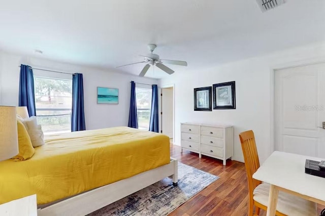 bedroom with dark wood-type flooring and ceiling fan