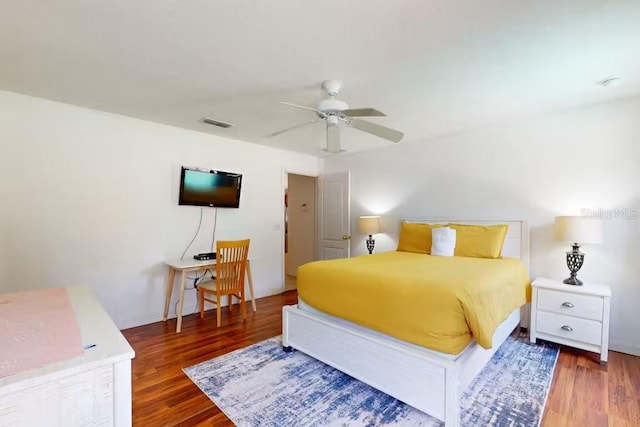 bedroom with ceiling fan and dark hardwood / wood-style floors