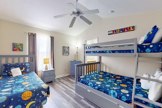 bedroom with lofted ceiling, hardwood / wood-style flooring, and ceiling fan