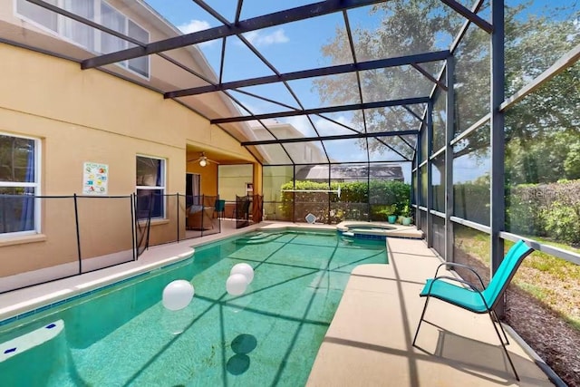 view of swimming pool featuring an in ground hot tub, a patio area, and a lanai