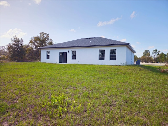 back of property featuring a lawn