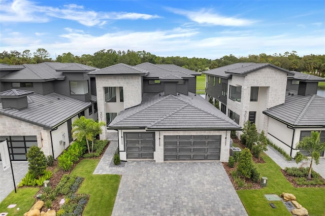 view of front of property with a garage and a front lawn