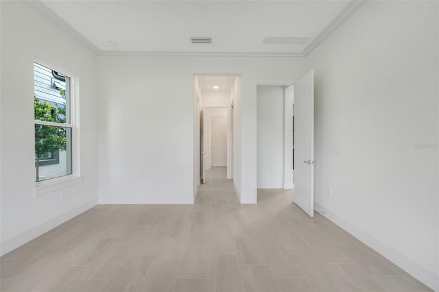 empty room featuring ornamental molding