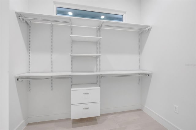 spacious closet featuring light tile patterned floors