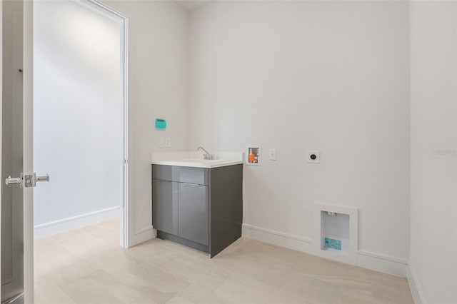 washroom featuring light tile patterned floors, sink, washer hookup, and electric dryer hookup