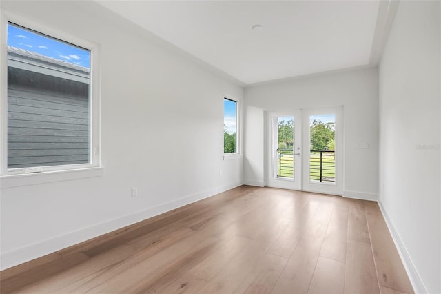 spare room with french doors and light hardwood / wood-style floors