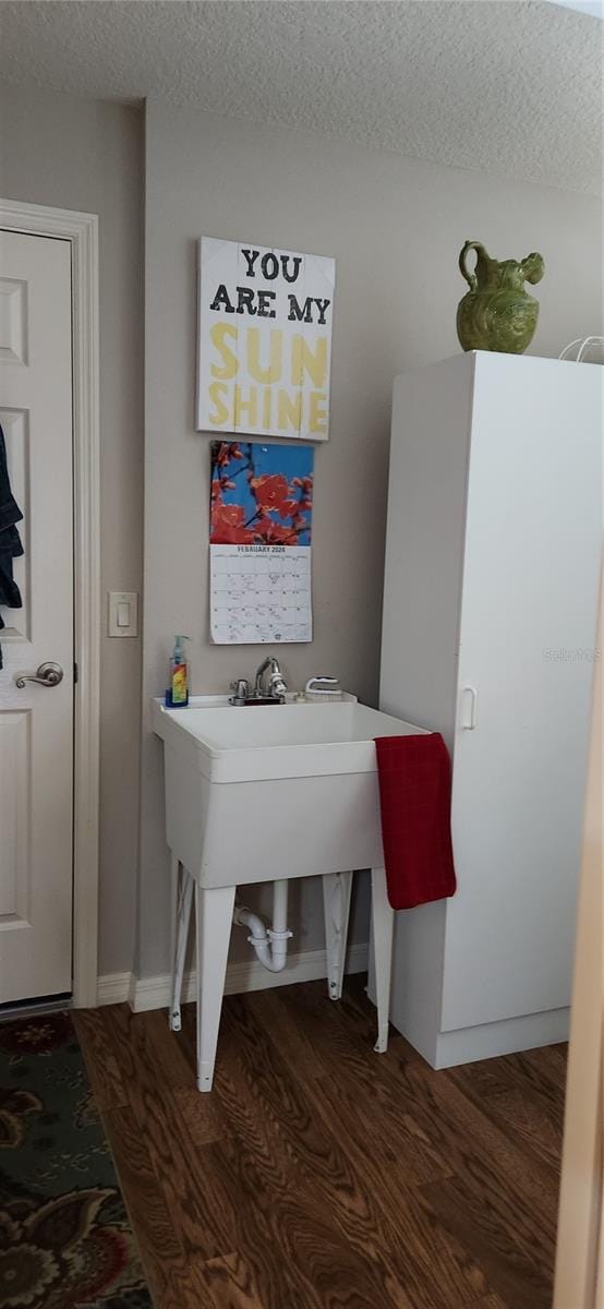 bathroom featuring hardwood / wood-style flooring and a textured ceiling