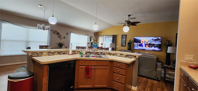 kitchen with dishwasher, dark hardwood / wood-style floors, a center island with sink, and vaulted ceiling