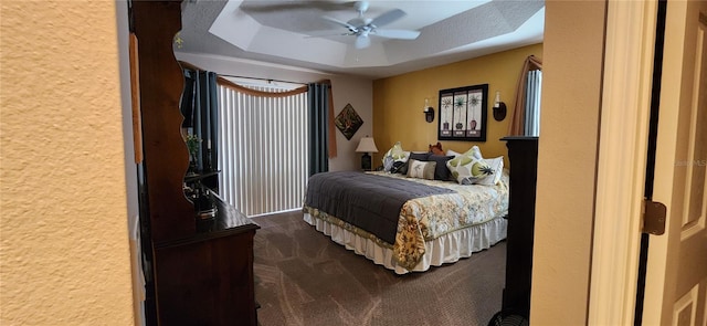 bedroom featuring ceiling fan, carpet flooring, and a textured ceiling