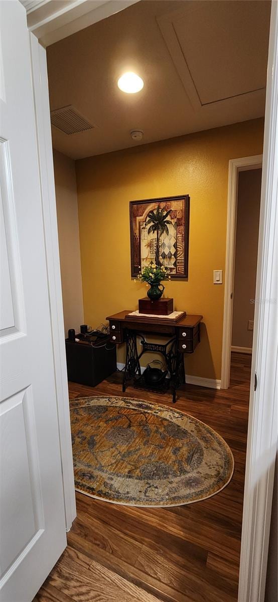 hallway with dark hardwood / wood-style flooring