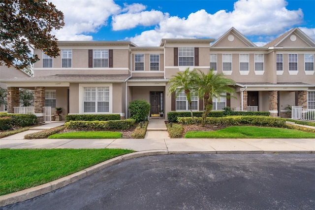 townhome / multi-family property with a porch