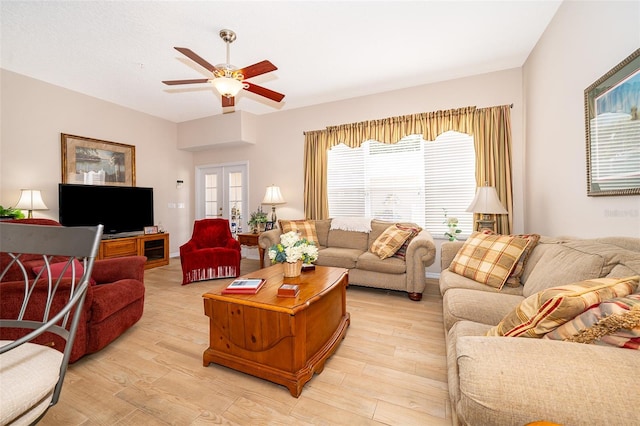 living room featuring ceiling fan, light hardwood / wood-style flooring, and french doors