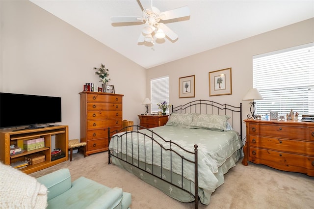 carpeted bedroom featuring ceiling fan and vaulted ceiling