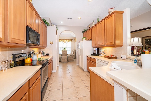 kitchen with stainless steel electric stove, sink, dishwasher, backsplash, and light tile patterned floors