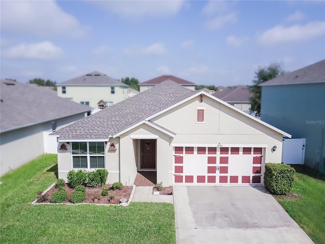 view of front of home with a front lawn and a garage