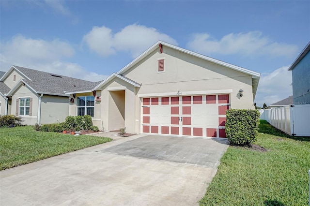 view of front of property with a front yard and a garage