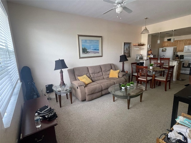 living room featuring carpet and ceiling fan