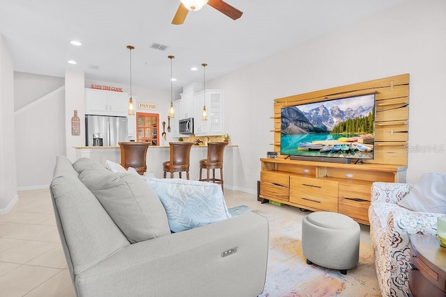 tiled living room featuring ceiling fan