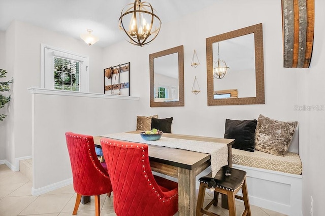 tiled dining room with an inviting chandelier