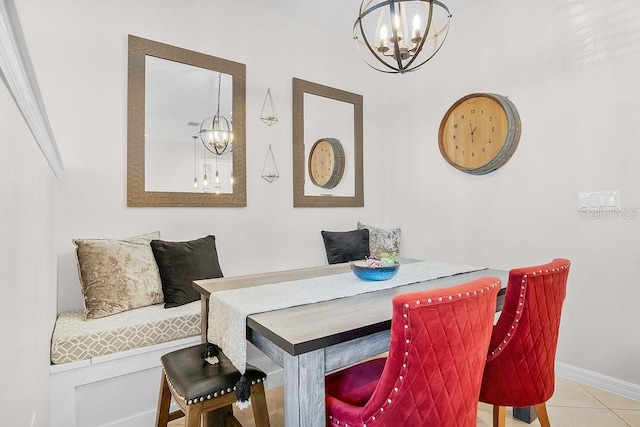 tiled dining area featuring an inviting chandelier