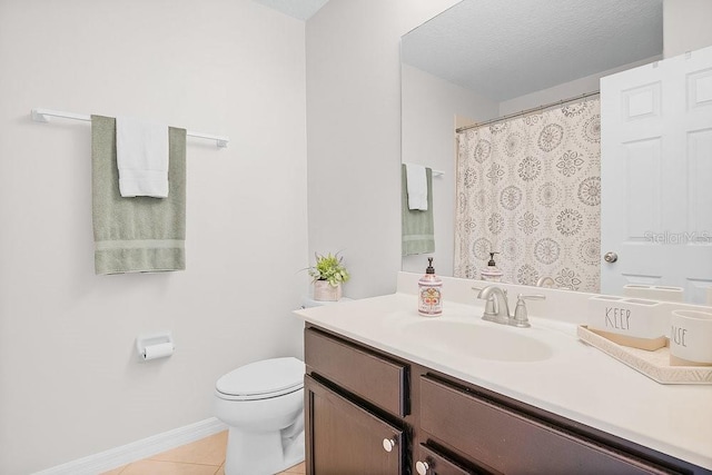 bathroom featuring tile patterned flooring, a textured ceiling, vanity, and toilet