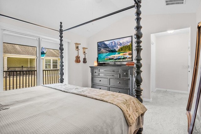 bedroom featuring lofted ceiling and light carpet