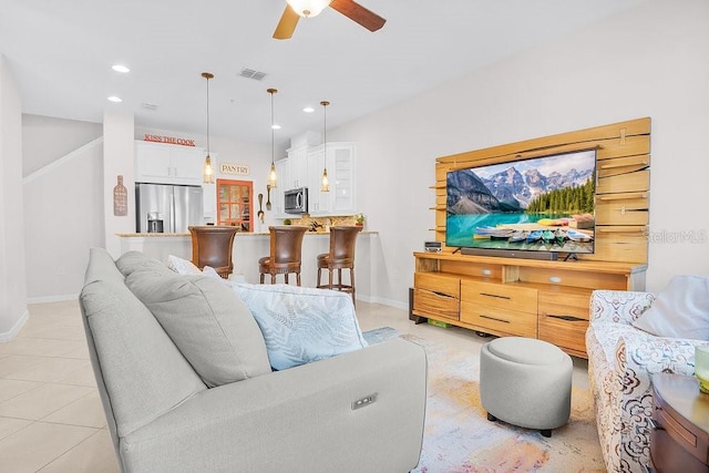 living room with light tile patterned floors, recessed lighting, visible vents, ceiling fan, and baseboards