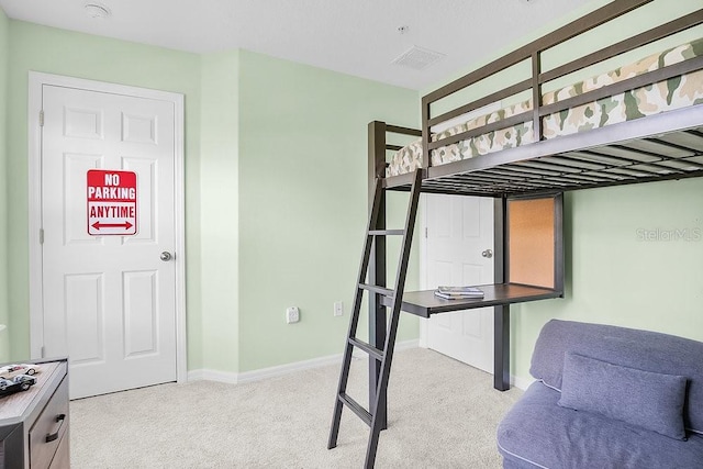 carpeted bedroom with visible vents and baseboards