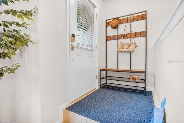 doorway featuring baseboards