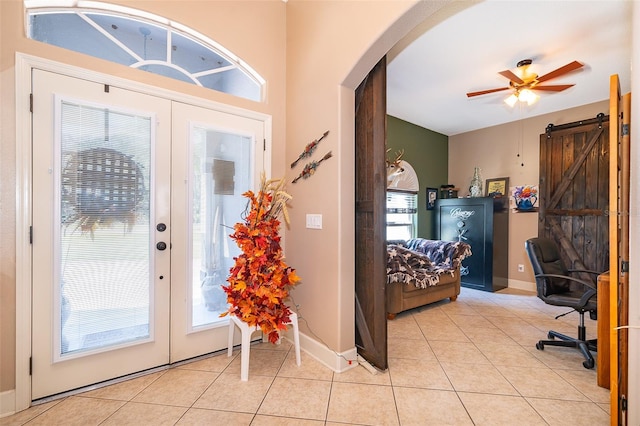 entryway featuring ceiling fan, plenty of natural light, and light tile patterned floors