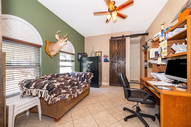 bedroom featuring light tile patterned flooring, ceiling fan, a barn door, and vaulted ceiling