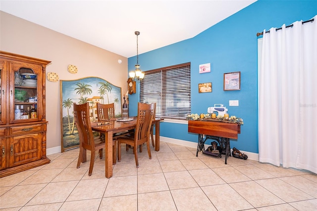 tiled dining area featuring a chandelier