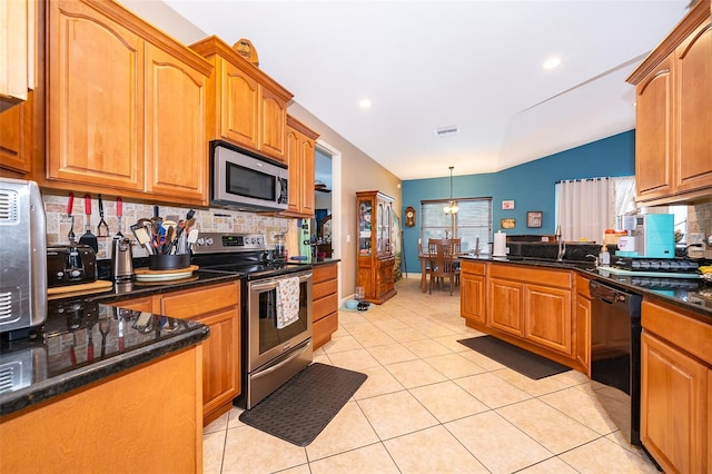 kitchen featuring hanging light fixtures, light tile patterned floors, sink, backsplash, and stainless steel appliances