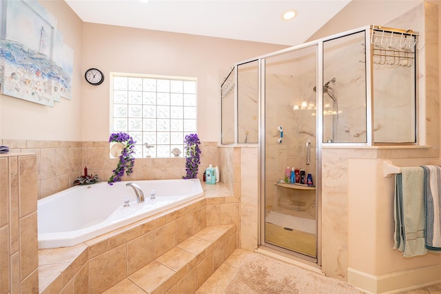 bathroom featuring lofted ceiling and independent shower and bath