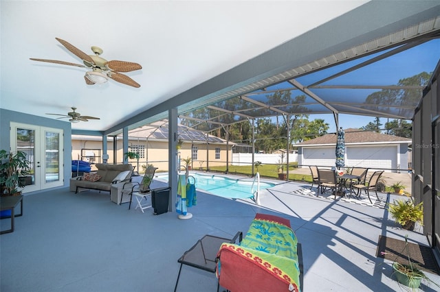 view of patio / terrace featuring a lanai, ceiling fan, and a fenced in pool