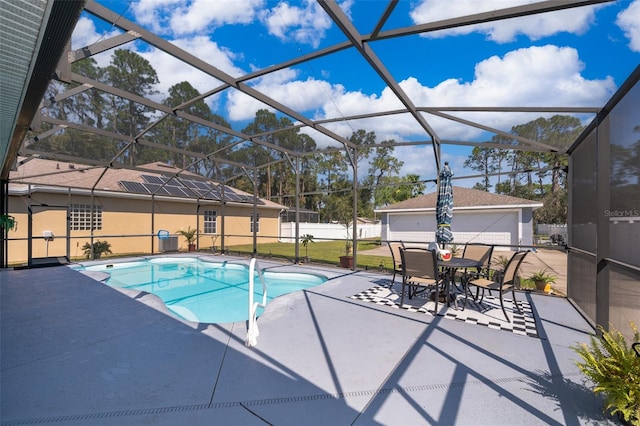 view of pool featuring glass enclosure and a patio area