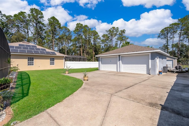 exterior space featuring a garage and a lawn